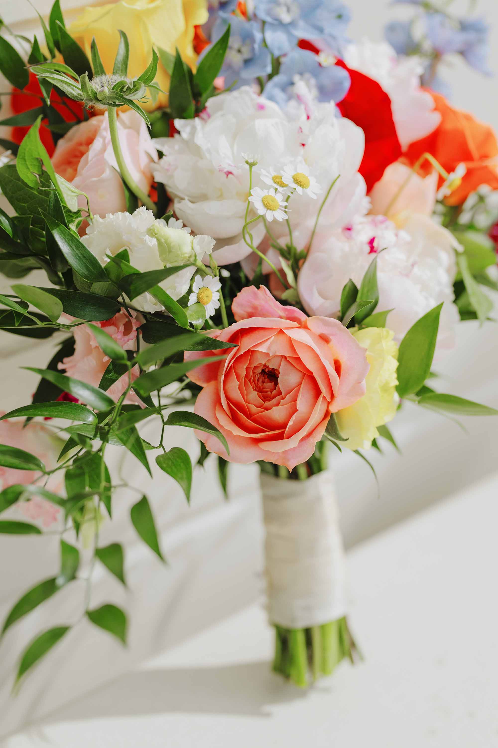wedding day photograph of bride's colorful bouquet, large blooms of every color