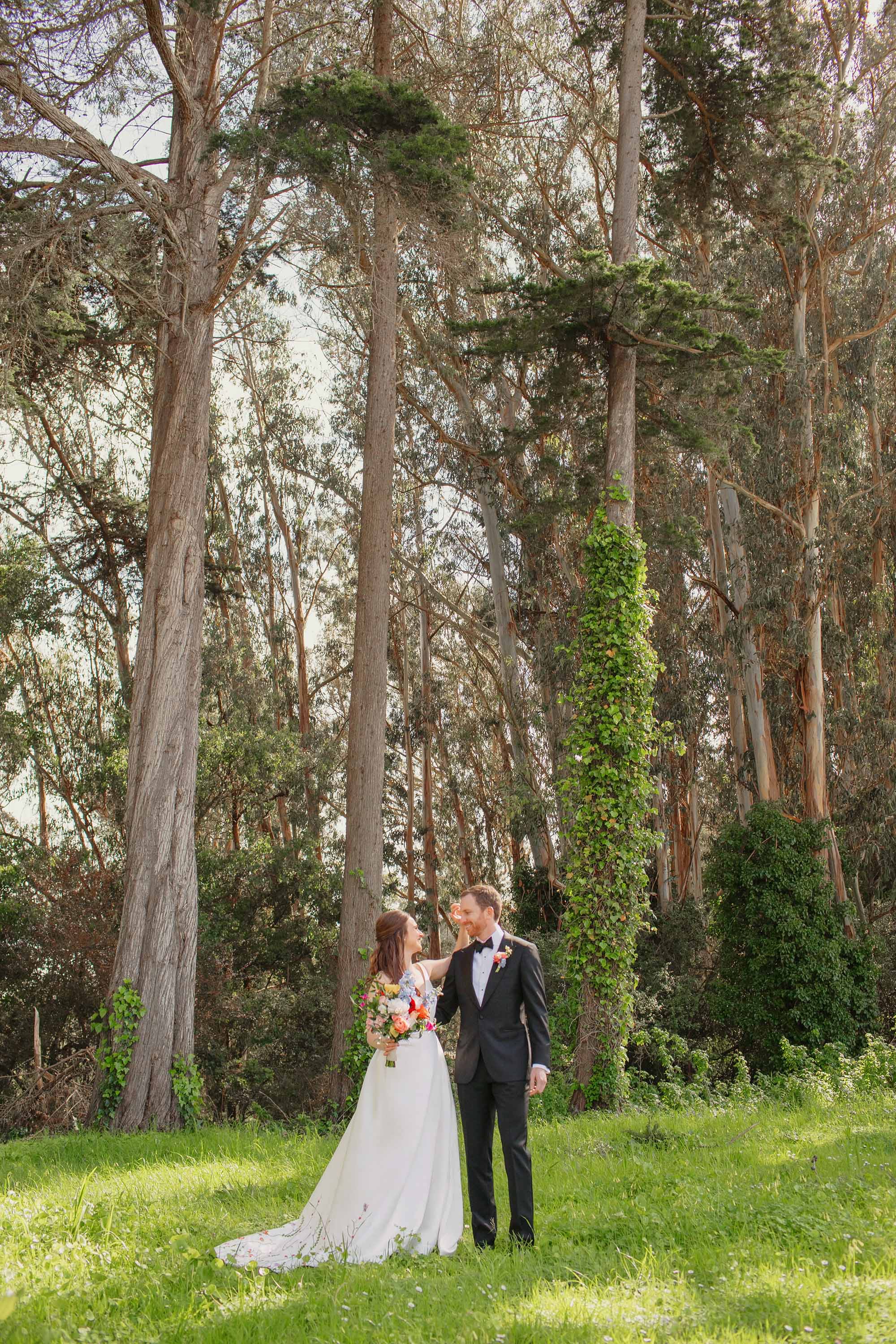 Bride fixes groom's hair during portrait session in San Francisco Presidio. Credit: Love Knot Photography by Isaac Klotz