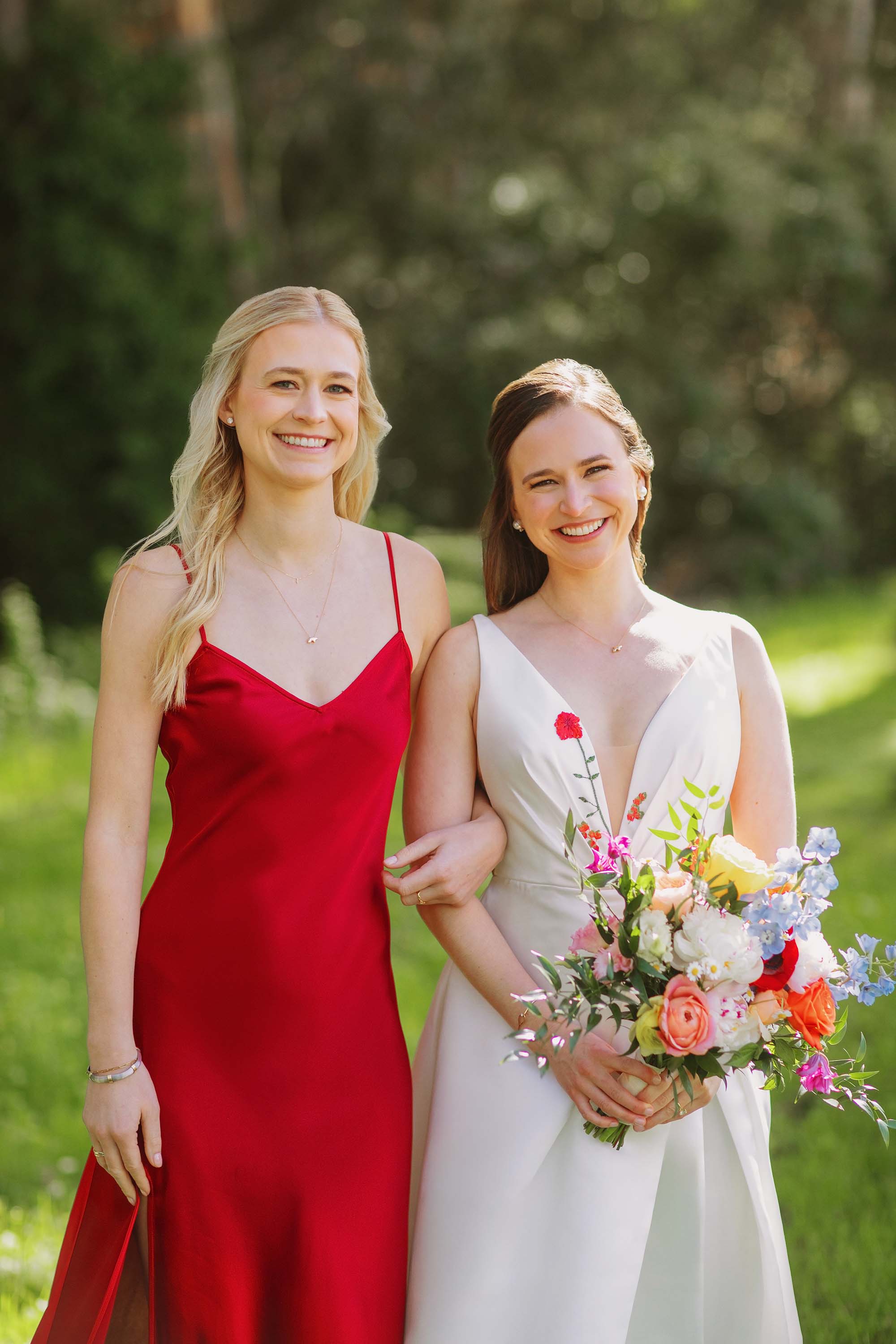 Bride with her sister, beautiful portrait with bride holding her colorful bouquet. Credit: Love Knot Photography by Isaac Klotz