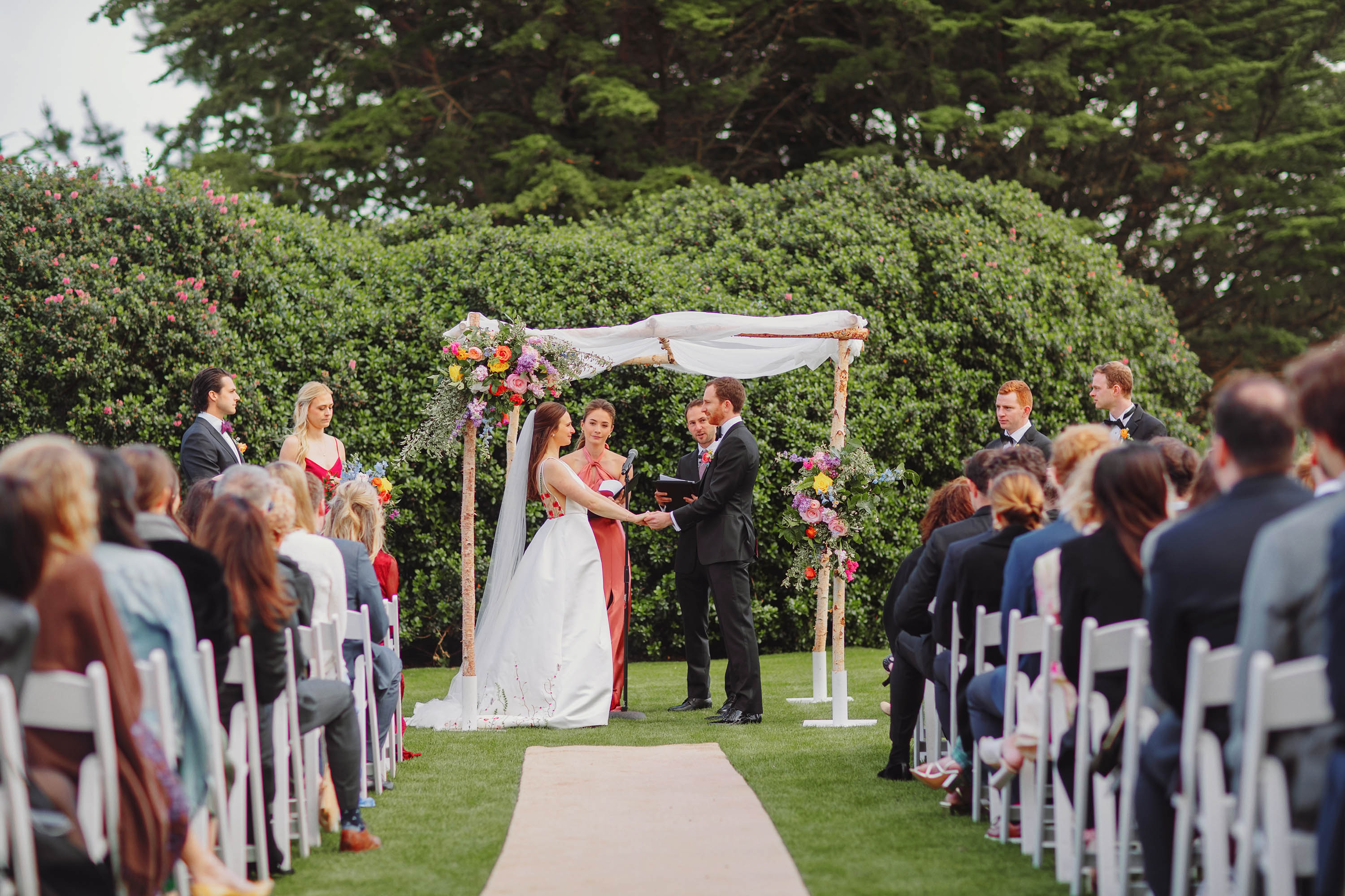 Bride and groom hold hands at the start of wedding ceremony in SF Presidio. Credit: Love Knot Photography by Isaac Klotz