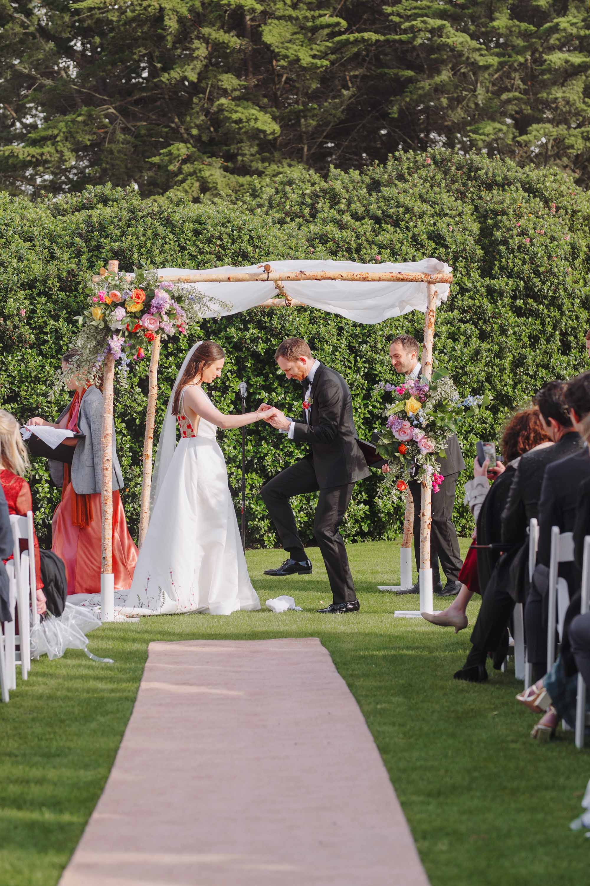 Wedding ceremony concludes with this photograph documenting a stomping of the glass. Credit: Love Knot Photography by Isaac Klotz
