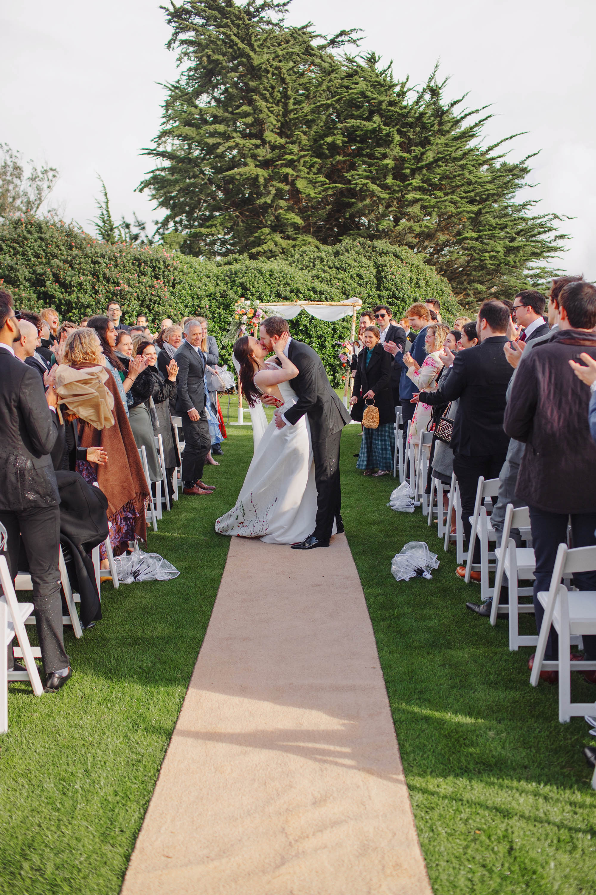 The bride and groom kiss again as they leave the ceremony in SF Presidio Golf Course. Credit: Love Knot Photography by Isaac Klotz