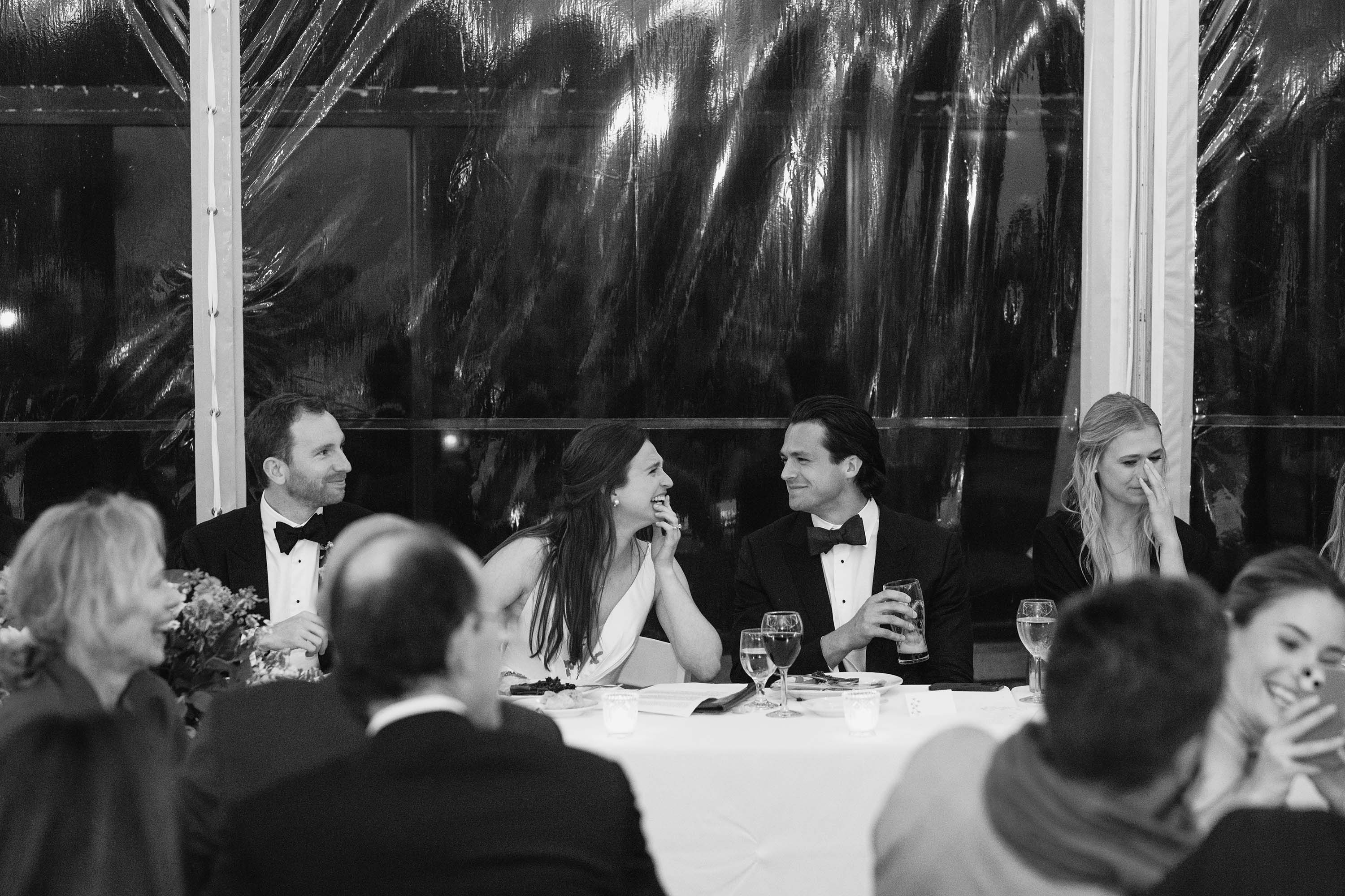 Bride listening with joy to wedding speech during the reception. Credit: Love Knot Photography by Isaac Klotz