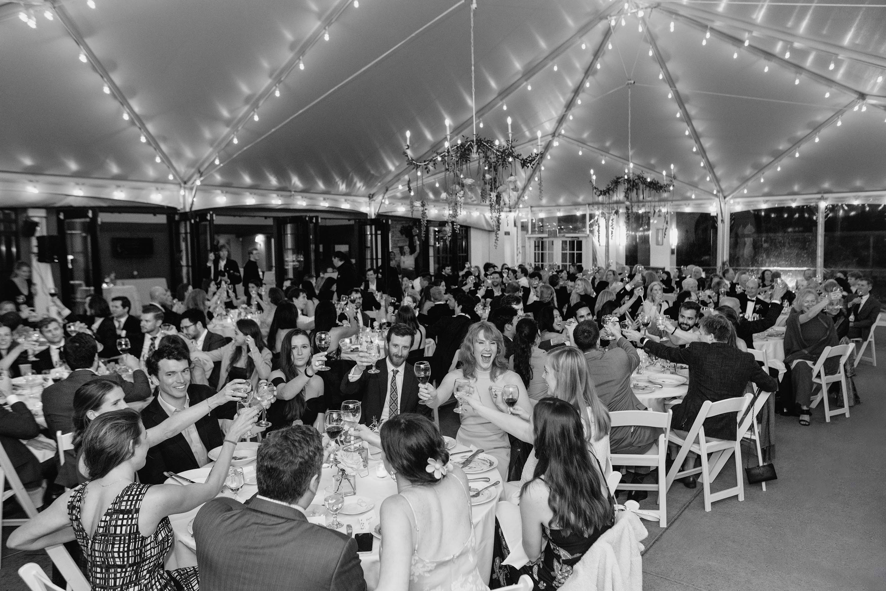 Candid photograph of toasts at wedding reception, SF Presidio Golf Course. Credit: Love Knot Photography by Isaac Klotz