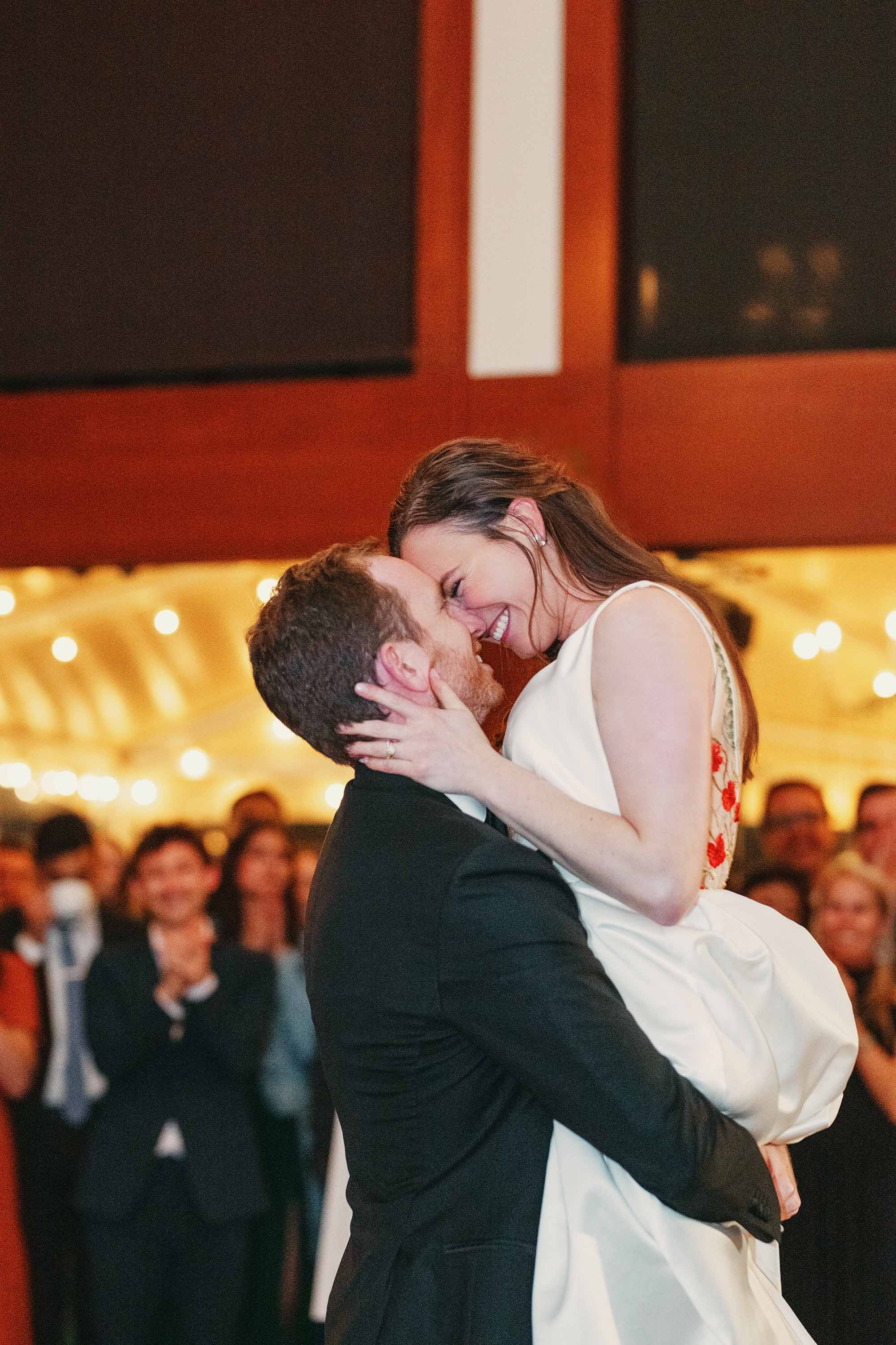Bride and groom kiss during their first dance at the wedding reception. Credit: Love Knot Photography by Isaac Klotz