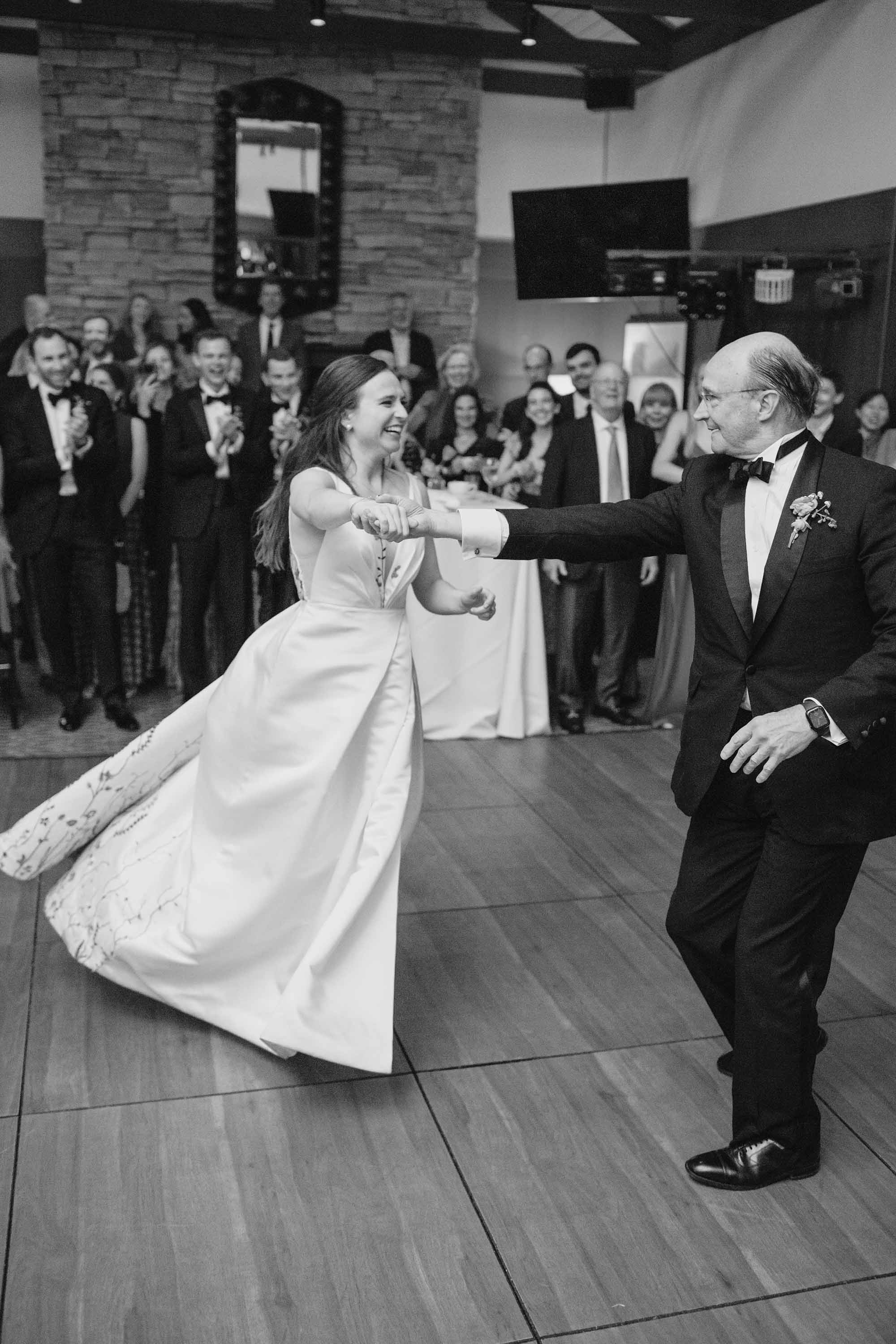 Great black and white photo of bride and her father dancing during the wedding reception.