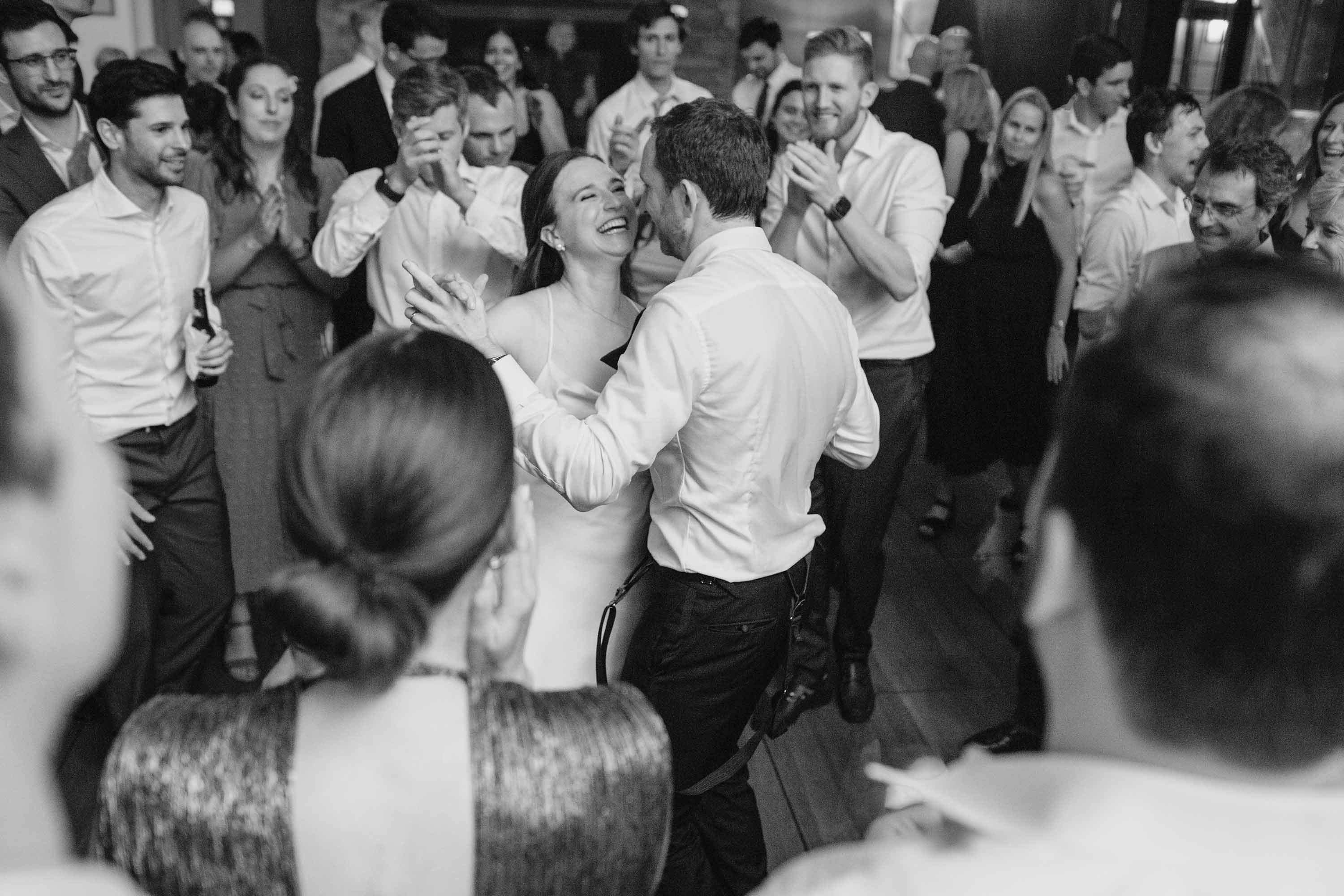 Wedding reception candid photos of everyone enjoying the dance floor with the bride and groom. Credit: Love Knot Photography by Isaac Klotz