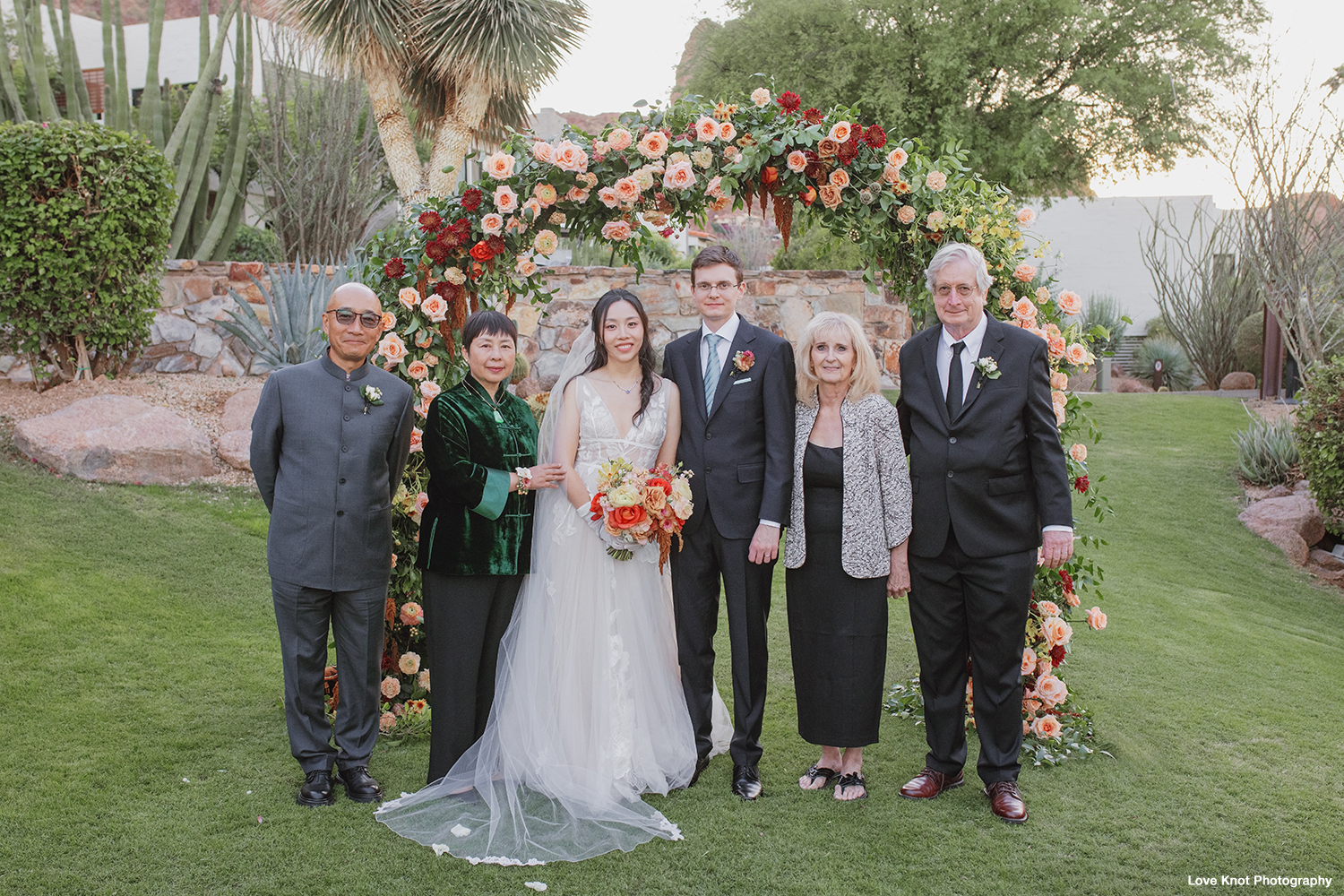 family portrait on wedding day bride and groom with parents