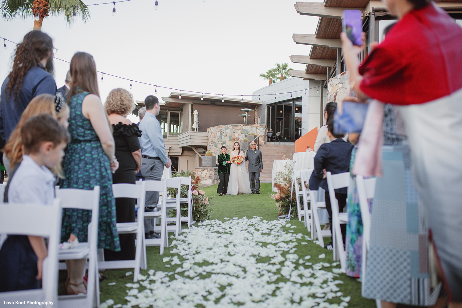 bride walking down aisle at wedding ceremony, photo by Love Knot Photography