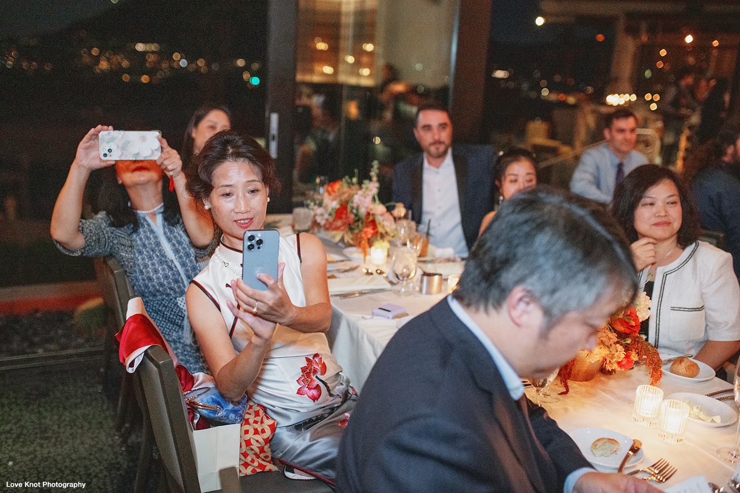 family listen to speeches at wedding reception