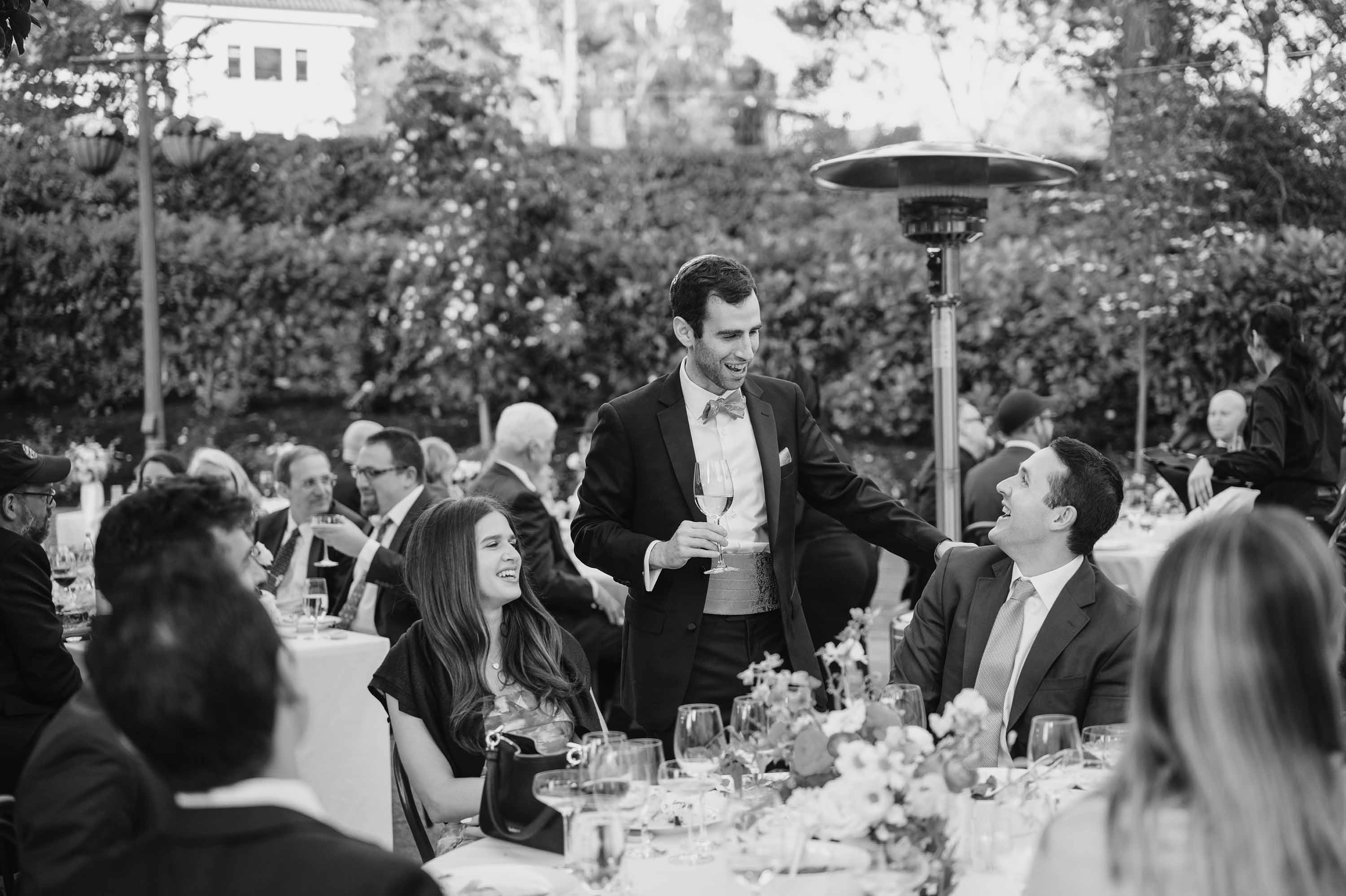 groom talking with guests during table visits
