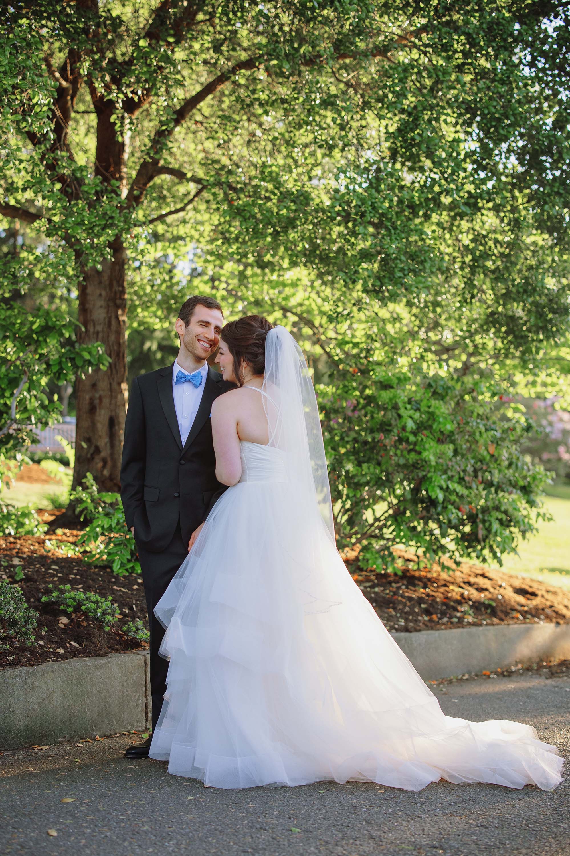 bride and groom share a candid moment together on wedding day