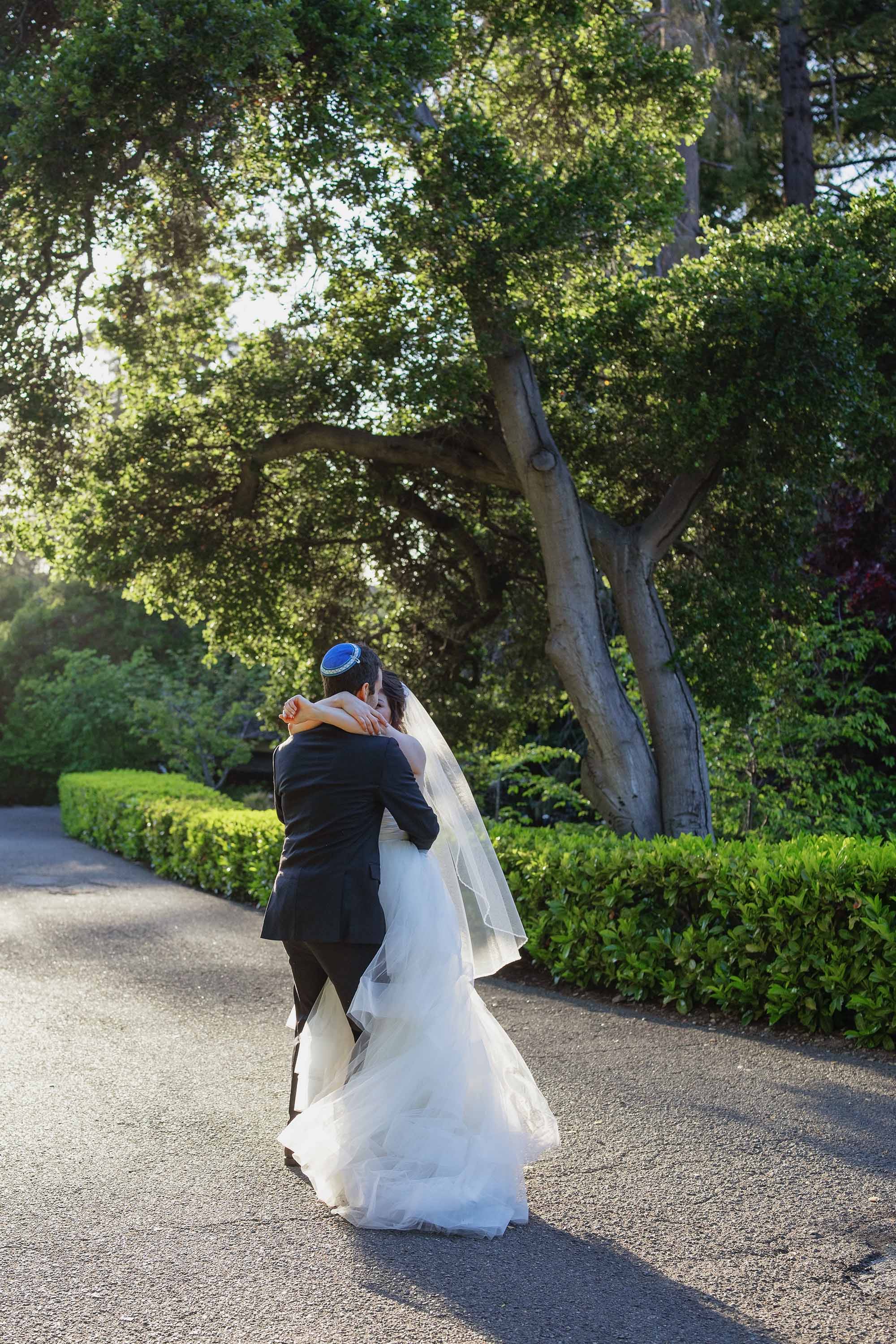 San Francisco Bay Area photographer captures candid moment of bride and groom hugging