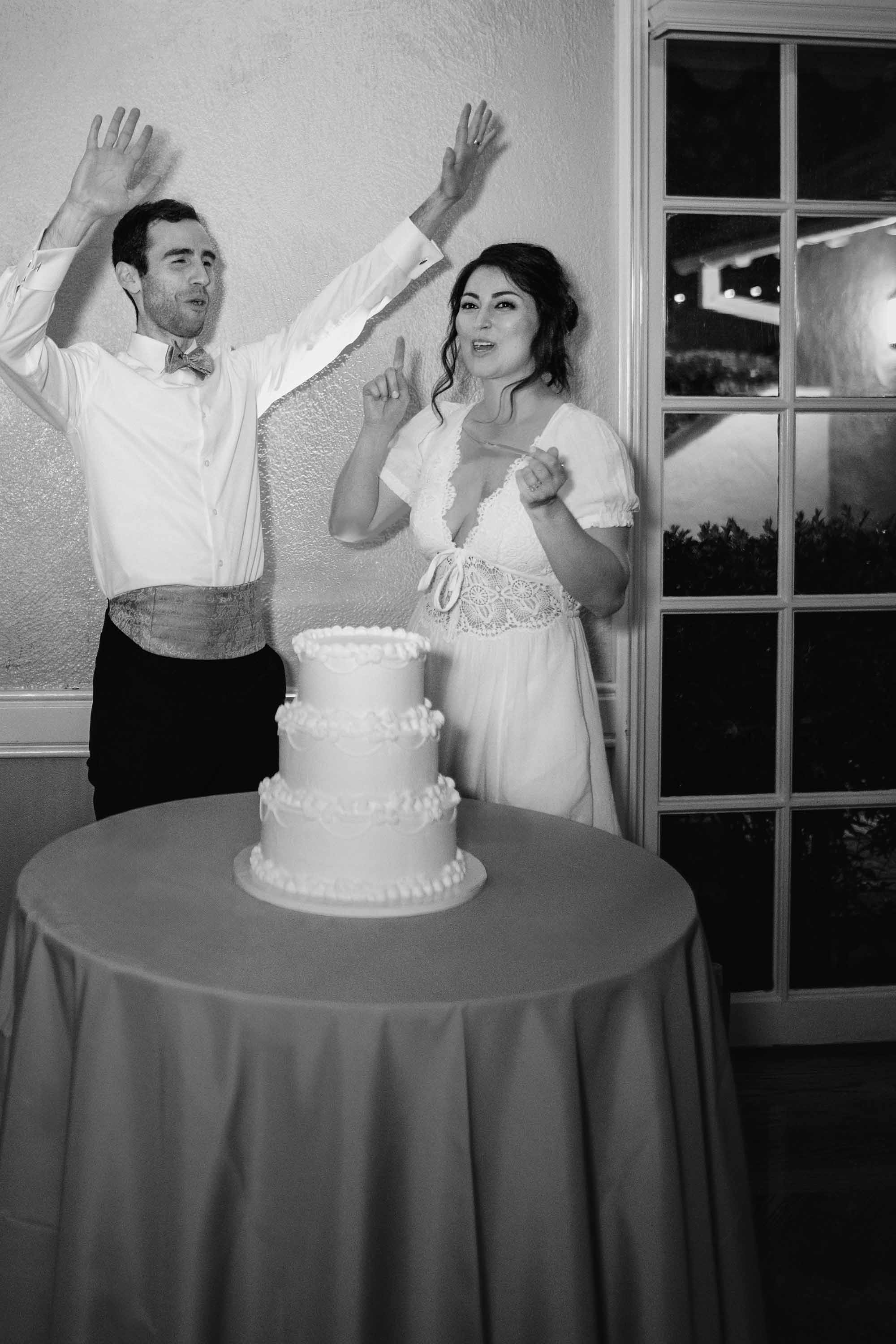 bride and groom cut the cake during their wedding reception in this beautiful photo by Love Knot Photography