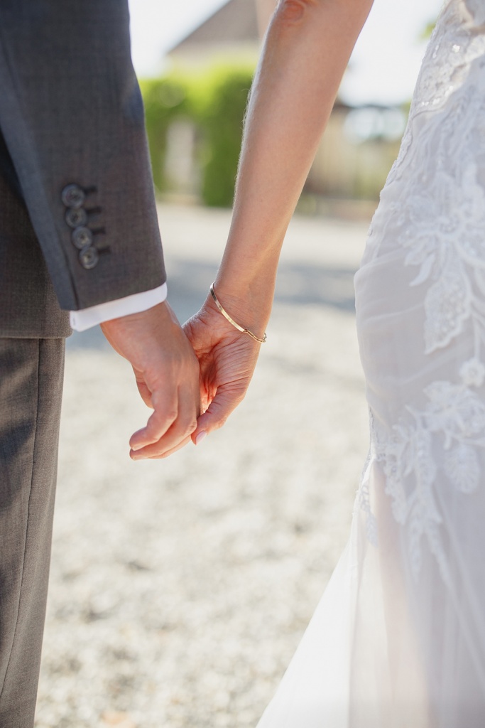 bride and groom holding hands on their wedding day